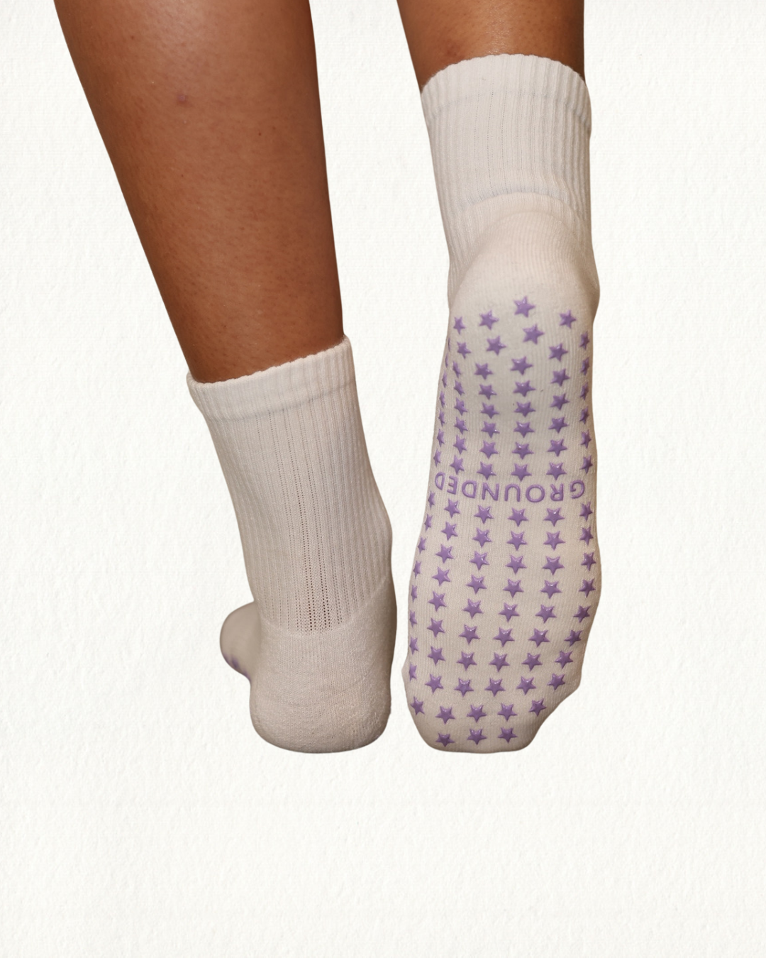 White barre socks with purple star pattern on a white background